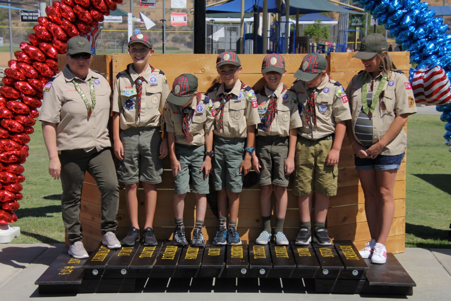 The crossover bridge that the graduating AOLs Scouts can walk across from the left side to the right side is situated up front. The Cubmaster and Assistant Cubmaster stand on the left side of the bridge. The troop representatives are called up and stand on the right side of the bridge.